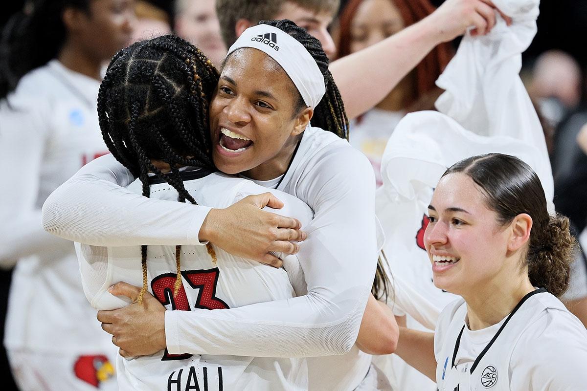 Chelsie Hall, Merissah Russell and Mykasa Robinson celebrate a Louisville victory.