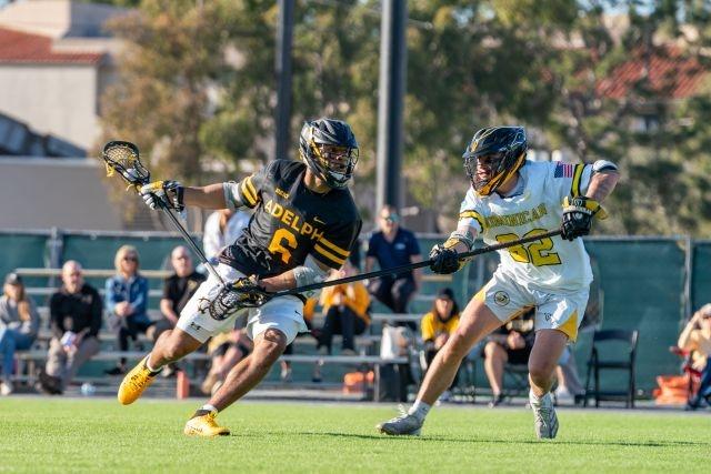 Kyle Lewis heads to the goal in an Adelphi men's lacrosse game. 