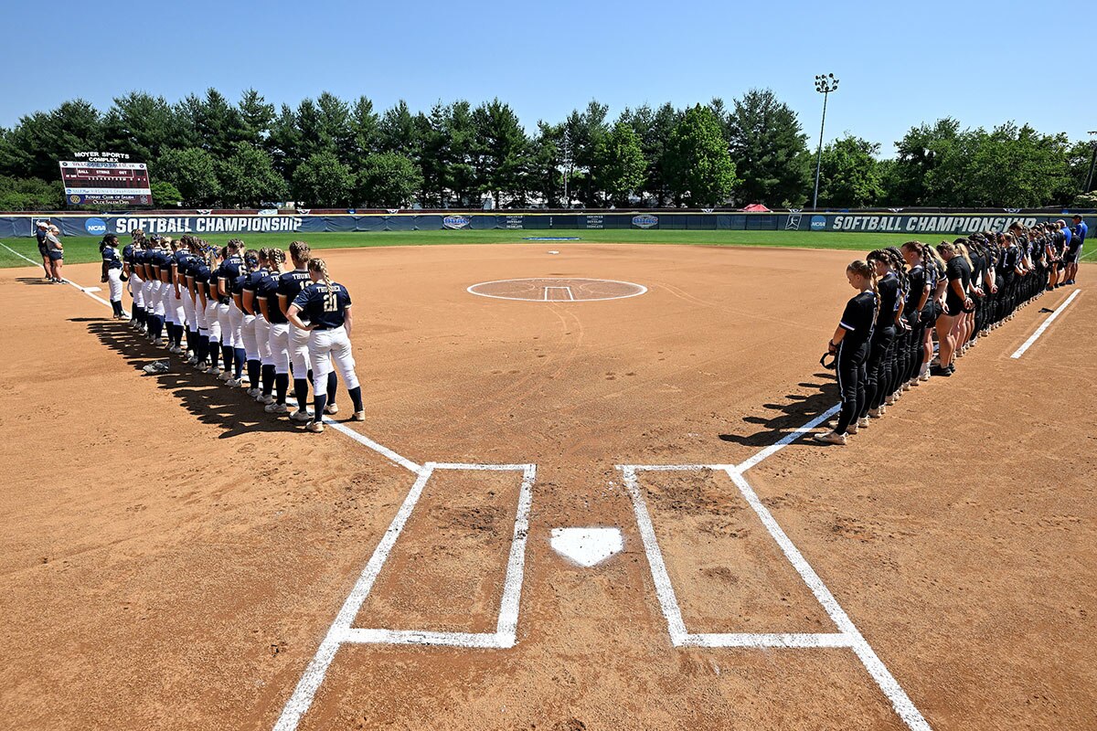 Christopher Newport and Trine stand for the national anthem at the 2022 DIII softball championship.